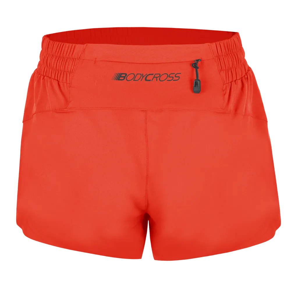 Short running trail femme BODYCROSS Alix orange vue de dos avec poche arrière zippée et logo BODYCROSS
